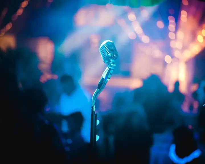 microphone at a bar or club with audience blurred and focus on the microphone